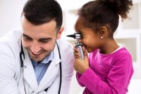 Doctor otologist palying with his patient